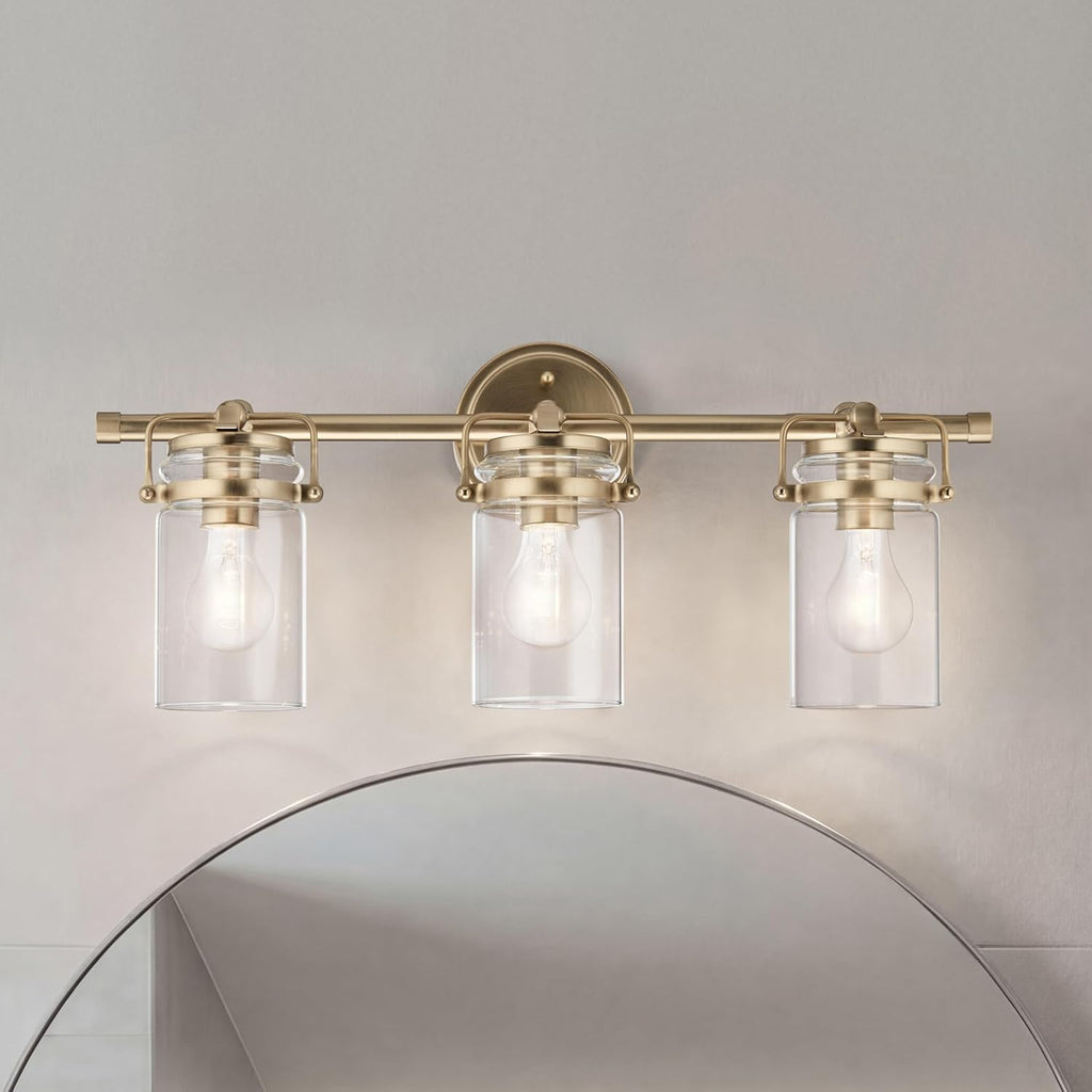 Kichler Brinley 24" 3-Light Bathroom Vanity Light Fixture with Clear Glass in Champagne Bronze, Modern Farmhouse Mason Jar Style for Mirror Lighting (24" W x 10.25" H), 45689CPZ